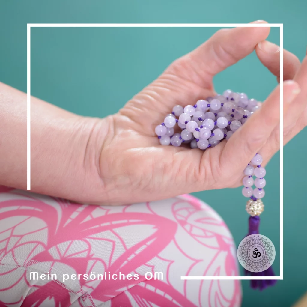 Hand mit violetter Mala in Mundra-Haltung